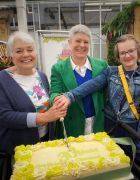 Three generations of Millbrook cutting the 30th birthday celebration cake.